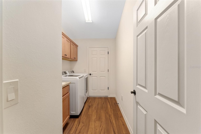1032 Kelsea Cir, The Villages, FL 32159 - laundry room featuring cabinet space, independent washer and dryer, and wood finished floors