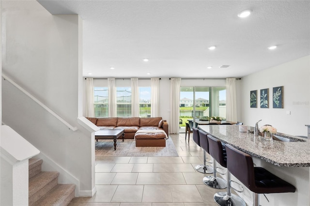 33675 Elm Hill Br, Wesley Chapel, FL 33545 - living room with plenty of natural light, recessed lighting, stairway, and light tile patterned flooring