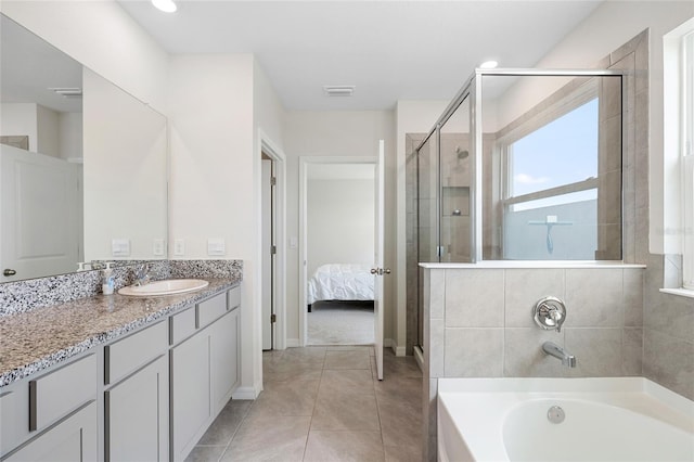 33675 Elm Hill Br, Wesley Chapel, FL 33545 - bathroom with vanity, a shower stall, a garden tub, tile patterned flooring, and ensuite bathroom