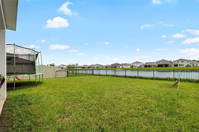 33675 Elm Hill Br, Wesley Chapel, FL 33545 - fenced backyard featuring a trampoline, a residential view, and a water view