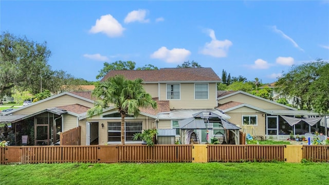 15636 Morning Dr, Lutz, FL 33559 - rear view of property featuring a sunroom, a gate, roof with shingles, and a gazebo
