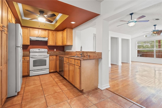 15636 Morning Dr, Lutz, FL 33559 - kitchen featuring white appliances, under cabinet range hood, a ceiling fan, stone countertops, and vaulted ceiling