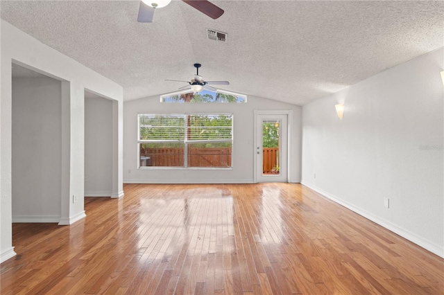 15636 Morning Dr, Lutz, FL 33559 - spare room with ceiling fan, healthy amount of natural light, a textured ceiling, lofted ceiling, and light wood-style flooring