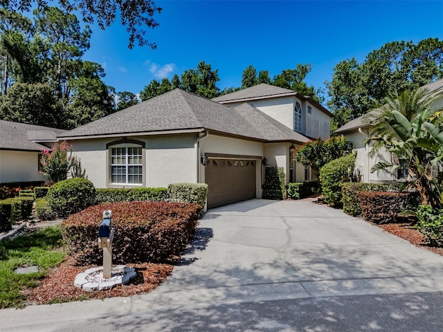 5224 Fairway One Dr, Valrico, FL 33596 - view of front of house with stucco siding, an attached garage, driveway, and a shingled roof