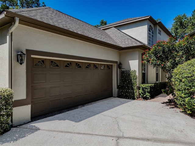 5224 Fairway One Dr, Valrico, FL 33596 - view of front of house featuring stucco siding, a garage, concrete driveway, and a shingled roof
