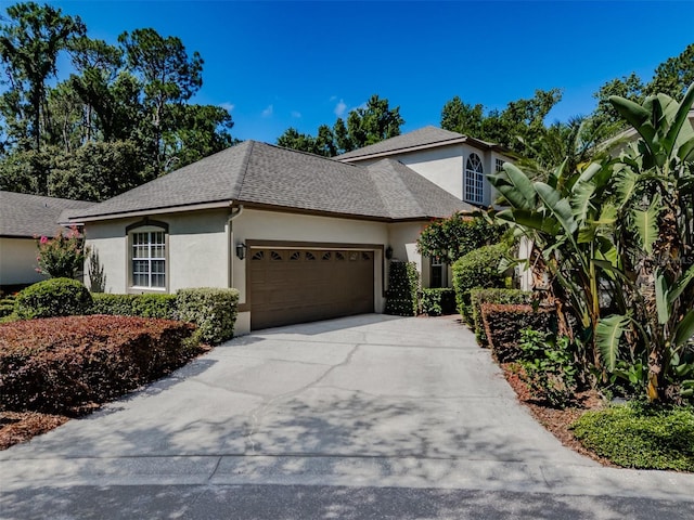 5224 Fairway One Dr, Valrico, FL 33596 - view of front facade featuring stucco siding, an attached garage, concrete driveway, and roof with shingles