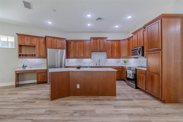 5224 Fairway One Dr, Valrico, FL 33596 - kitchen featuring stainless steel appliances, light countertops, brown cabinets, and recessed lighting