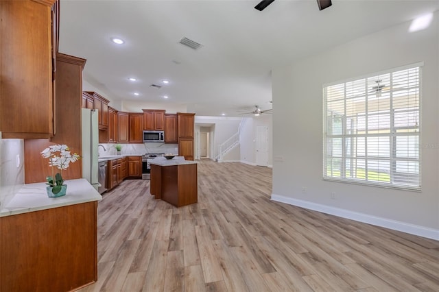 5224 Fairway One Dr, Valrico, FL 33596 - kitchen with appliances with stainless steel finishes, a ceiling fan, a kitchen island, light countertops, and recessed lighting