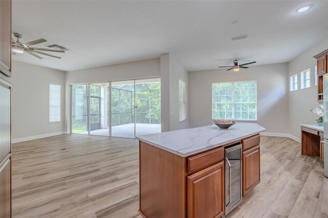 5224 Fairway One Dr, Valrico, FL 33596 - kitchen with wine cooler, a ceiling fan, open floor plan, and light wood finished floors