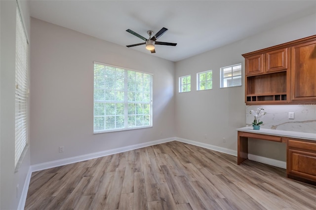5224 Fairway One Dr, Valrico, FL 33596 - unfurnished dining area with built in study area, light wood-type flooring, and ceiling fan