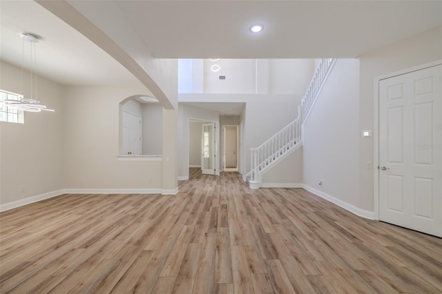 5224 Fairway One Dr, Valrico, FL 33596 - entryway featuring light wood-style floors, arched walkways, recessed lighting, and stairs