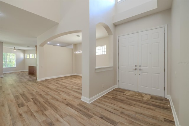 5224 Fairway One Dr, Valrico, FL 33596 - foyer with arched walkways, light wood-type flooring, and ceiling fan