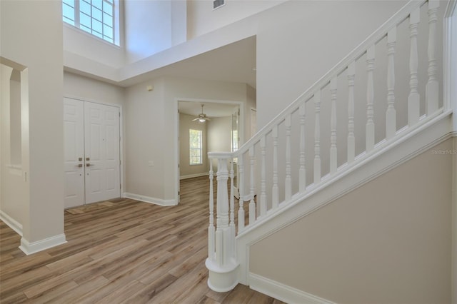 5224 Fairway One Dr, Valrico, FL 33596 - foyer with a towering ceiling, wood finished floors, a ceiling fan, and stairway