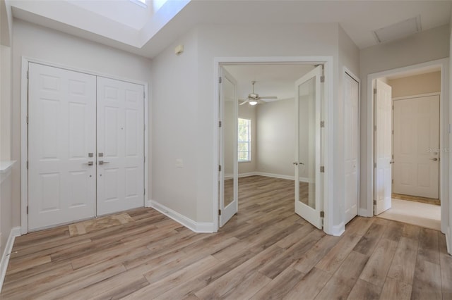 5224 Fairway One Dr, Valrico, FL 33596 - foyer entrance featuring light wood-style flooring, a skylight, ceiling fan, and french doors