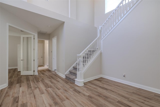 5224 Fairway One Dr, Valrico, FL 33596 - foyer with stairway, light wood-style flooring, and a high ceiling