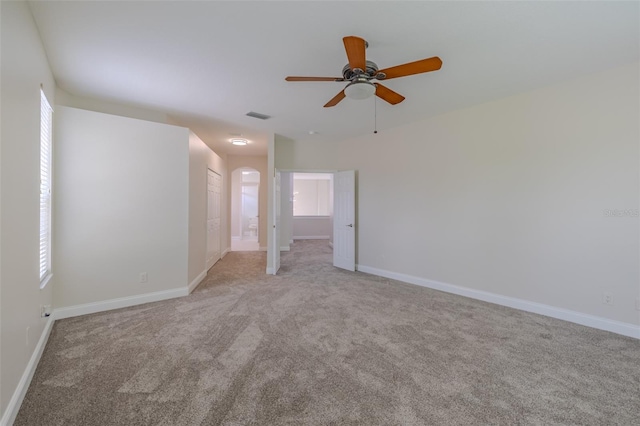 5224 Fairway One Dr, Valrico, FL 33596 - unfurnished room with light colored carpet, a ceiling fan, and arched walkways