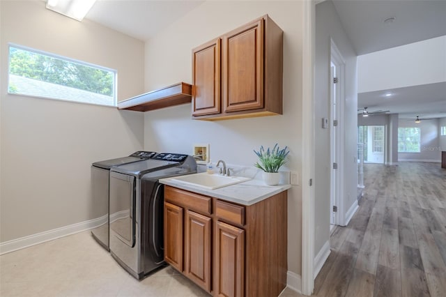 5224 Fairway One Dr, Valrico, FL 33596 - washroom with cabinet space, washer and dryer, light wood finished floors, and ceiling fan