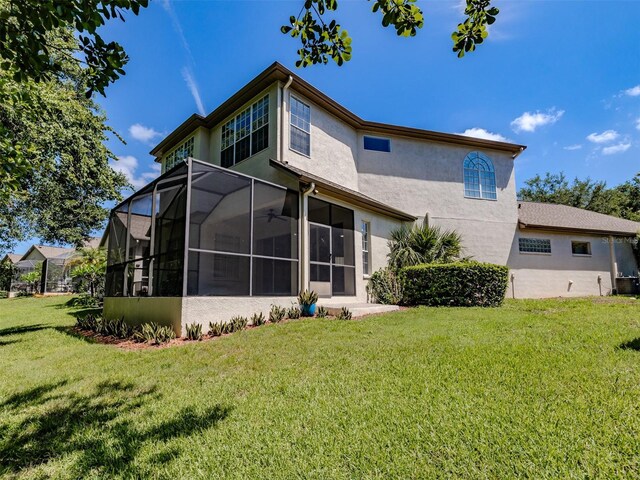 5224 Fairway One Dr, Valrico, FL 33596 - back of house featuring stucco siding and a lawn