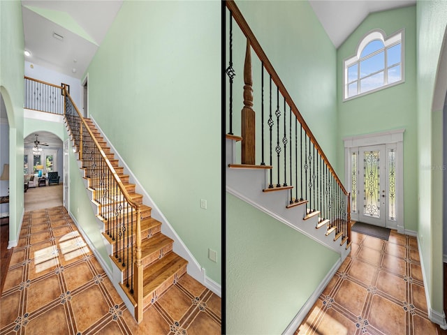 7427 20th St, Zephyrhills, FL 33540 - stairs with high vaulted ceiling, arched walkways, ceiling fan, and tile patterned floors