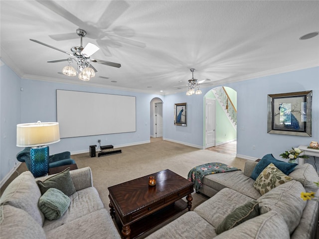 7427 20th St, Zephyrhills, FL 33540 - living room with arched walkways, a ceiling fan, stairs, ornamental molding, and carpet floors