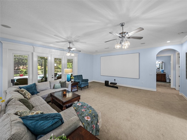 7427 20th St, Zephyrhills, FL 33540 - living room featuring arched walkways, carpet flooring, a ceiling fan, and ornamental molding