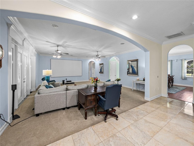 7427 20th St, Zephyrhills, FL 33540 - living area with arched walkways, ceiling fan, crown molding, and recessed lighting