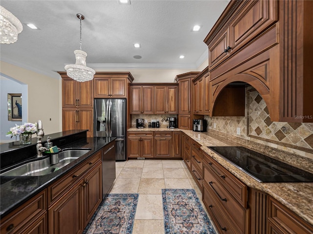 7427 20th St, Zephyrhills, FL 33540 - kitchen with stainless steel appliances, a chandelier, crown molding, tasteful backsplash, and arched walkways
