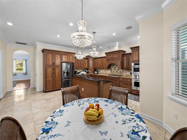 7427 20th St, Zephyrhills, FL 33540 - dining room featuring arched walkways, a chandelier, ornamental molding, light tile patterned floors, and recessed lighting