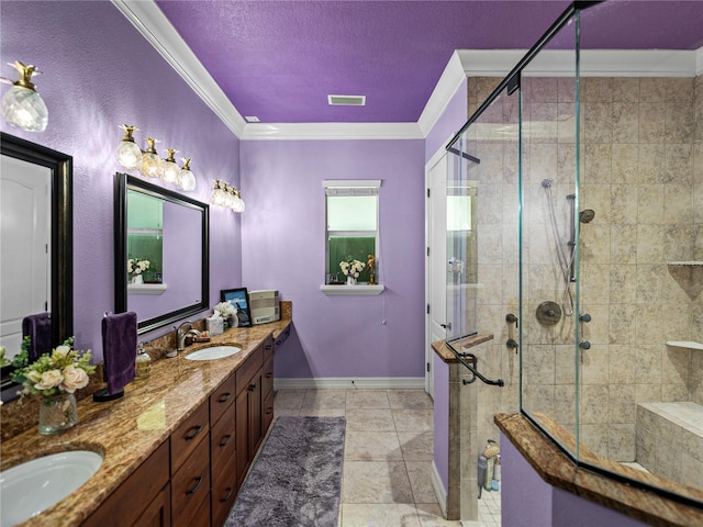 7427 20th St, Zephyrhills, FL 33540 - bathroom featuring crown molding, double vanity, a stall shower, tile patterned flooring, and a textured ceiling