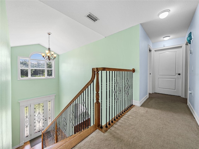 7427 20th St, Zephyrhills, FL 33540 - hall with a chandelier, carpet flooring, and vaulted ceiling