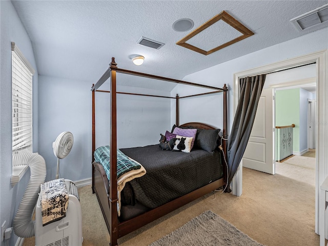 7427 20th St, Zephyrhills, FL 33540 - carpeted bedroom featuring attic access and a textured ceiling