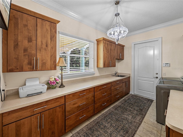 7427 20th St, Zephyrhills, FL 33540 - kitchen featuring a chandelier, independent washer and dryer, ornamental molding, light countertops, and decorative light fixtures