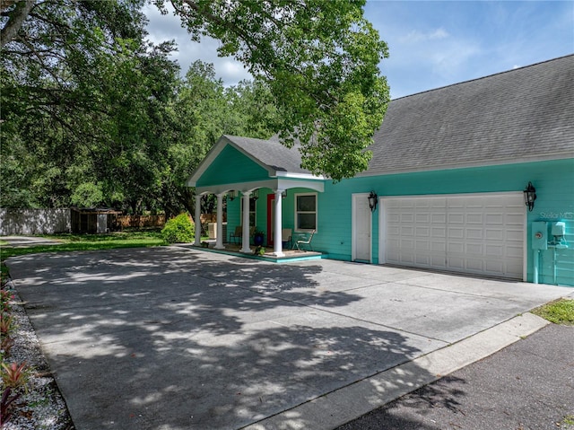 7427 20th St, Zephyrhills, FL 33540 - view of front facade with a shingled roof, driveway, and a garage