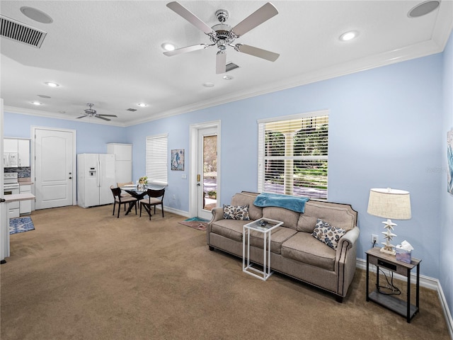 7427 20th St, Zephyrhills, FL 33540 - living area with ceiling fan, light carpet, ornamental molding, and recessed lighting