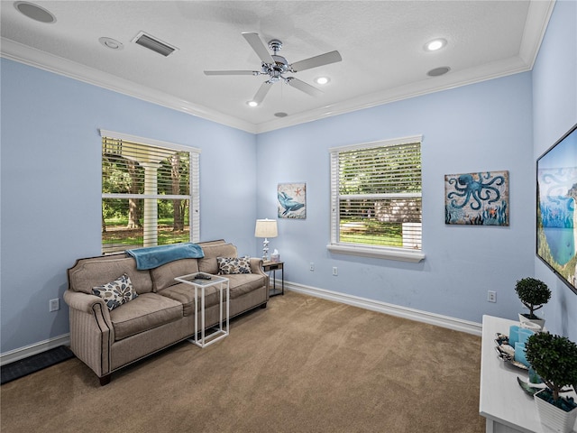 7427 20th St, Zephyrhills, FL 33540 - carpeted living area with ornamental molding, plenty of natural light, a ceiling fan, and recessed lighting
