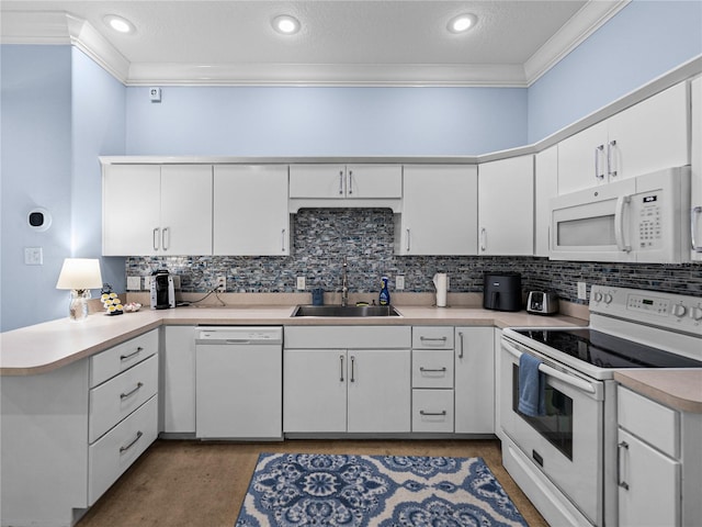 7427 20th St, Zephyrhills, FL 33540 - kitchen with white appliances, crown molding, a peninsula, decorative backsplash, and white cabinetry