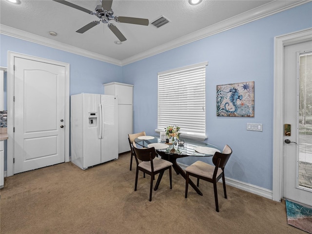 7427 20th St, Zephyrhills, FL 33540 - dining space with light colored carpet, ornamental molding, and ceiling fan