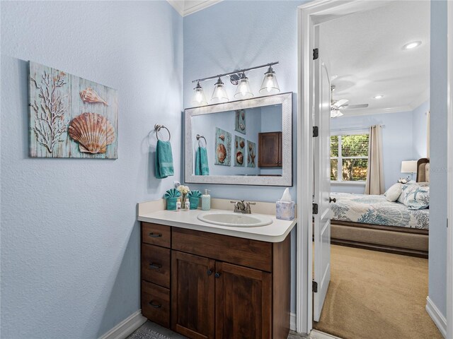 7427 20th St, Zephyrhills, FL 33540 - bathroom featuring vanity, ornamental molding, ensuite bathroom, ceiling fan, and recessed lighting
