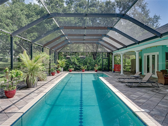 7427 20th St, Zephyrhills, FL 33540 - swimming pool featuring french doors, a patio area, and glass enclosure