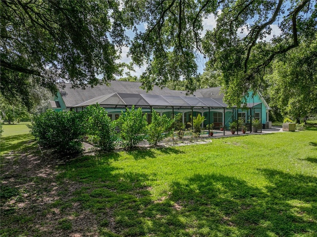 7427 20th St, Zephyrhills, FL 33540 - view of green lawn featuring a lanai and a swimming pool