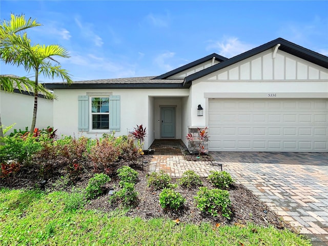 5336 Patano Loop, Palmetto, FL 34221 - ranch-style house with stucco siding, a garage, and driveway