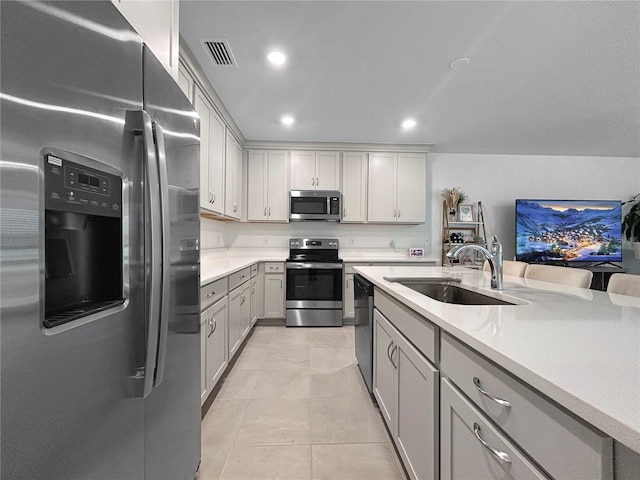 5336 Patano Loop, Palmetto, FL 34221 - kitchen featuring stainless steel appliances, light countertops, gray cabinets, light tile patterned floors, and recessed lighting
