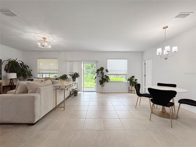 5336 Patano Loop, Palmetto, FL 34221 - living area with a chandelier and light tile patterned flooring