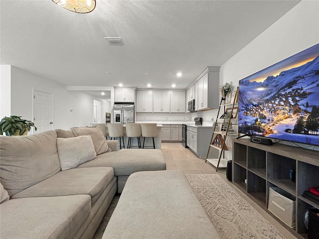 5336 Patano Loop, Palmetto, FL 34221 - living room featuring recessed lighting, a textured ceiling, and light tile patterned floors