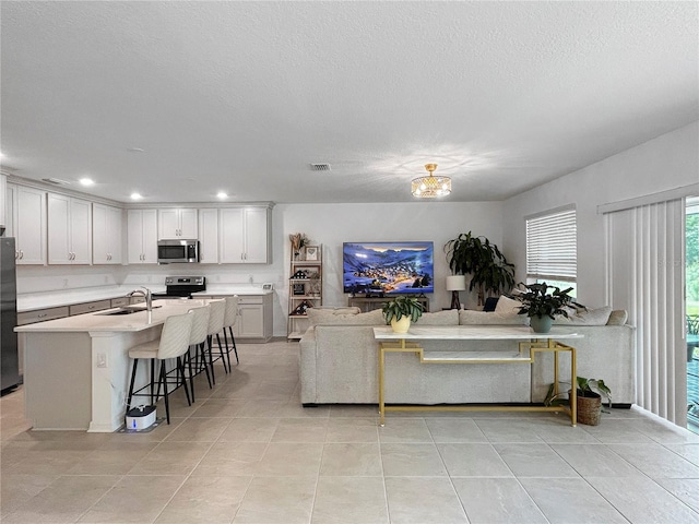 5336 Patano Loop, Palmetto, FL 34221 - living area with light tile patterned floors, recessed lighting, a textured ceiling, and a chandelier