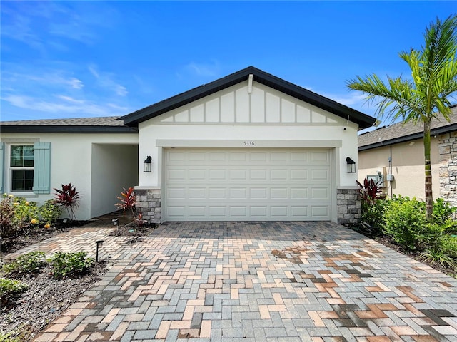 5336 Patano Loop, Palmetto, FL 34221 - ranch-style house featuring stone siding, decorative driveway, stucco siding, and an attached garage