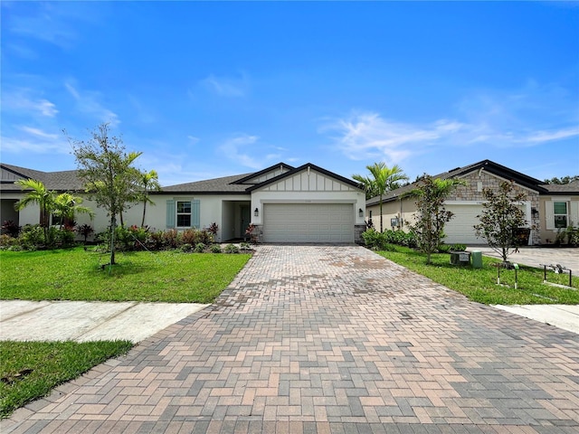5336 Patano Loop, Palmetto, FL 34221 - single story home featuring decorative driveway, a front lawn, an attached garage, stucco siding, and board and batten siding