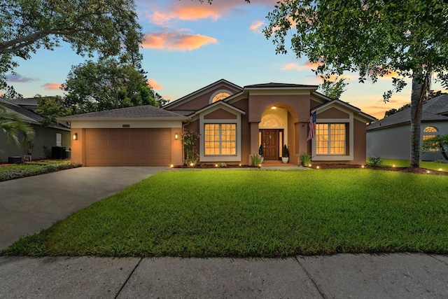 9206 Brindlewood Dr, Odessa, FL 33556 - ranch-style home featuring stucco siding, an attached garage, concrete driveway, and a lawn