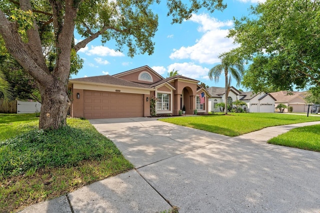 9206 Brindlewood Dr, Odessa, FL 33556 - view of front facade featuring stucco siding, an attached garage, concrete driveway, and a front yard