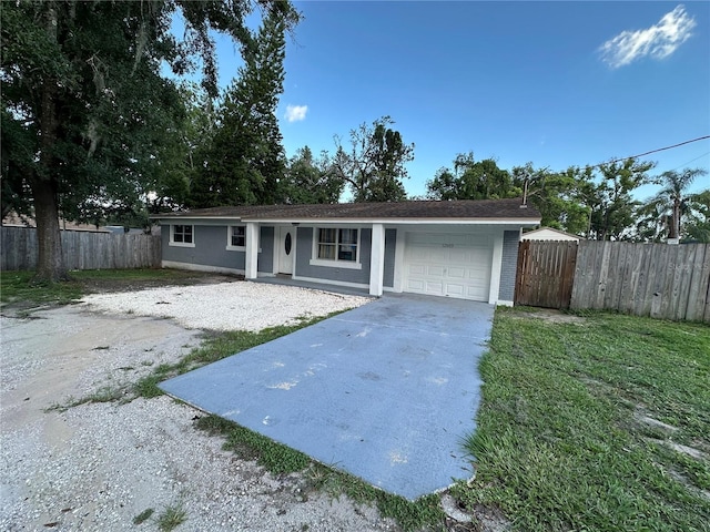 12009 Washington St, Seffner, FL 33584 - ranch-style house with an attached garage, concrete driveway, and covered porch